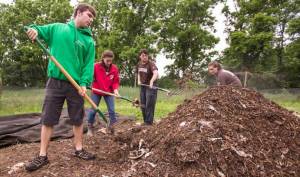 The GR2OW team turns the compost pile at the Lehigh Community Garden on the Goodman campus. From left, Alec Entress, Tori Wiedorn, Ben Cicchillo and Aly Lang.